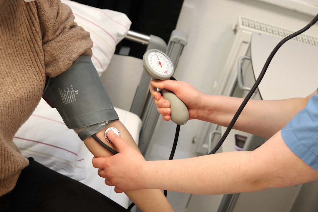 A person checking their blood pressure with a home monitor