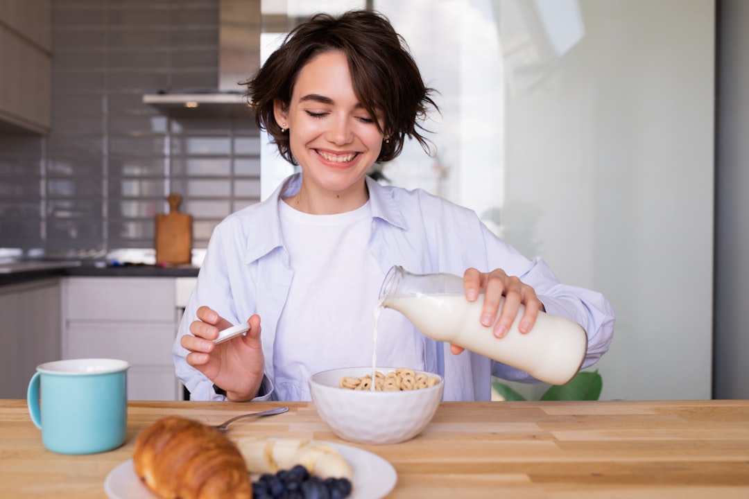 Woman pouring milk, a calcium-rich food that supports bone health