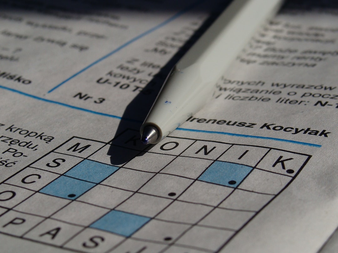 A pen resting on a crossword puzzle
