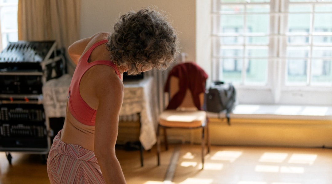 Woman stretching gently in a sunlit room to support joint health