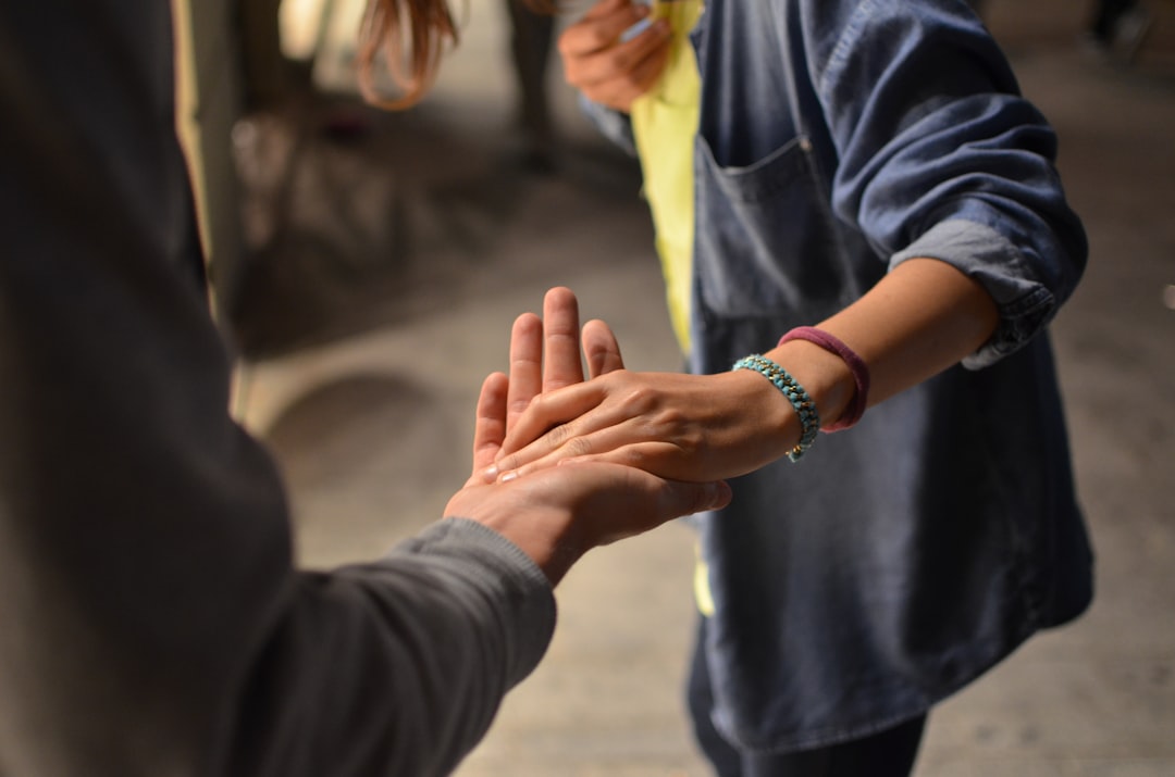 Two hands meeting palm to palm in comfort