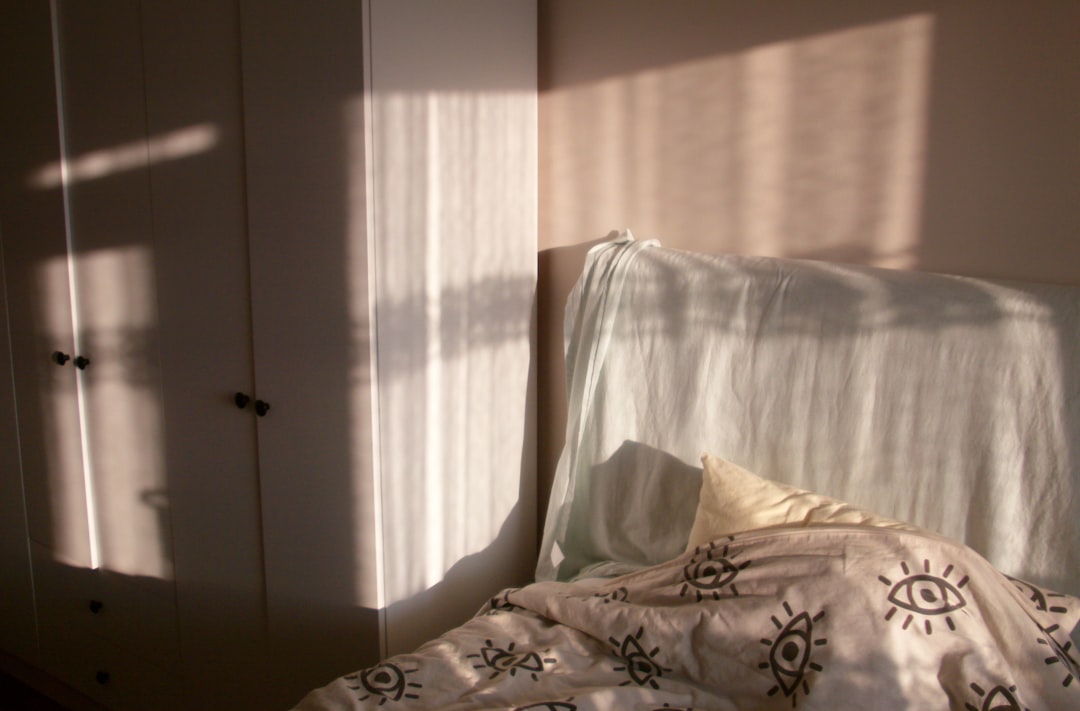 Sunlight streaming across a bed and bedroom in the morning