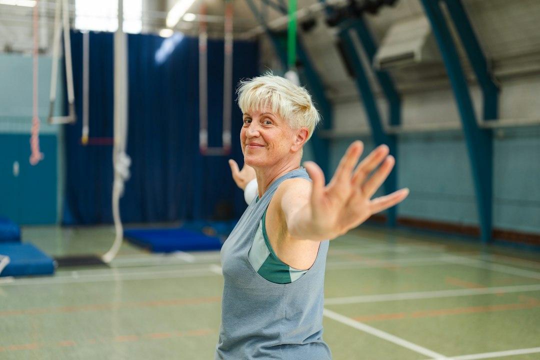 An older woman with short blonde hair in a gym