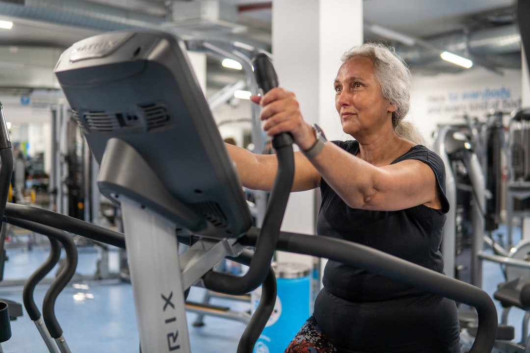 Older woman doing strength training at the gym to support bone density