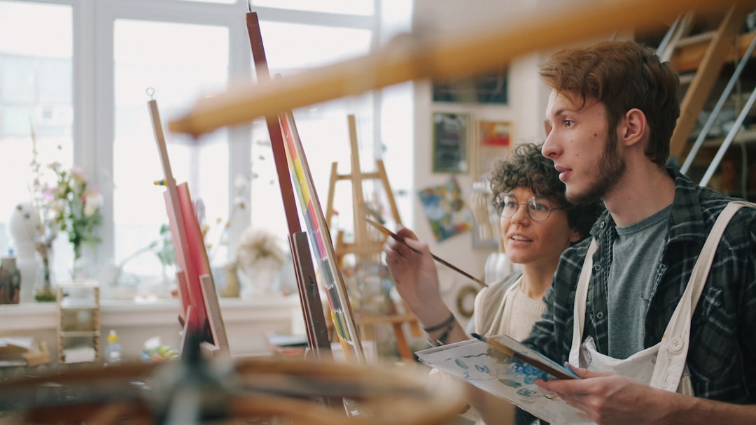 Two people painting together in an art studio