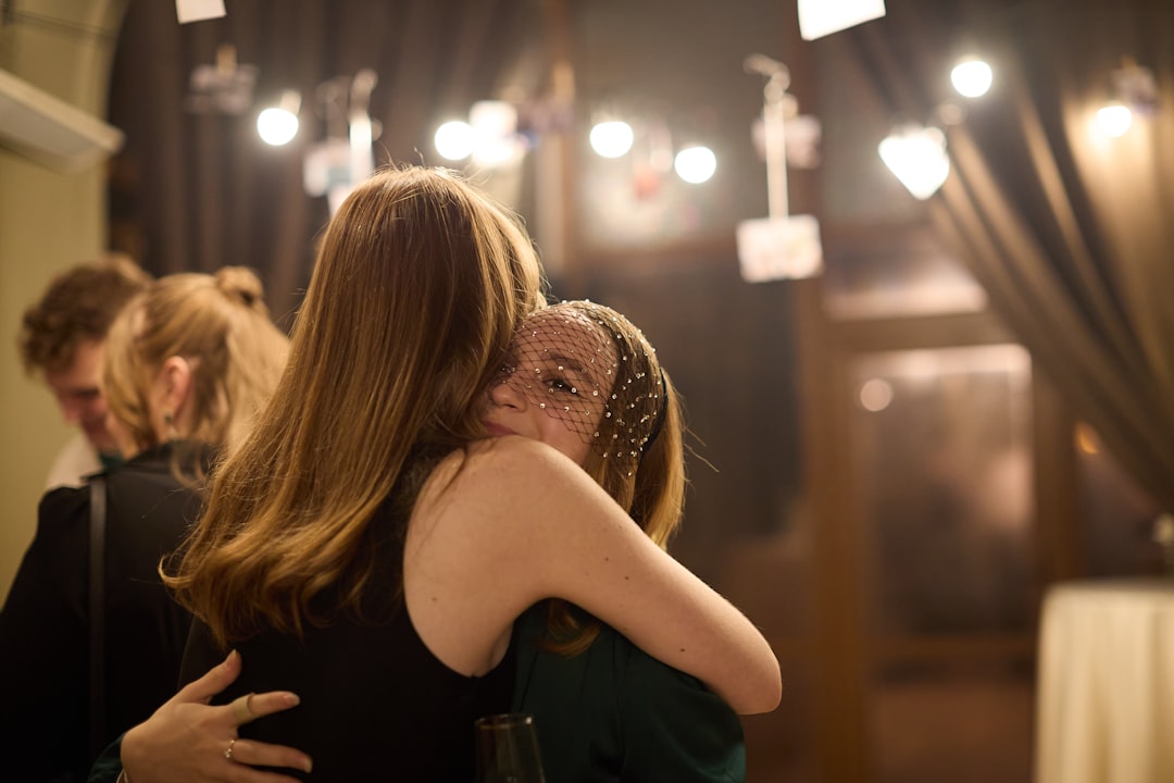 Two women embracing warmly indoors