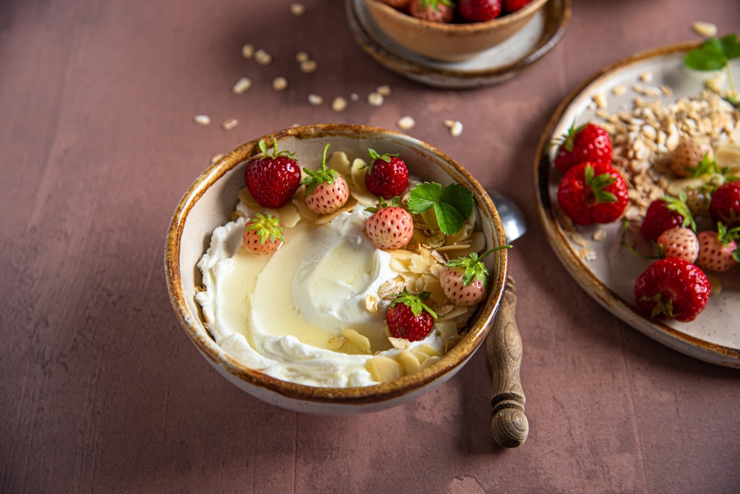 A bowl of yogurt topped with strawberries
