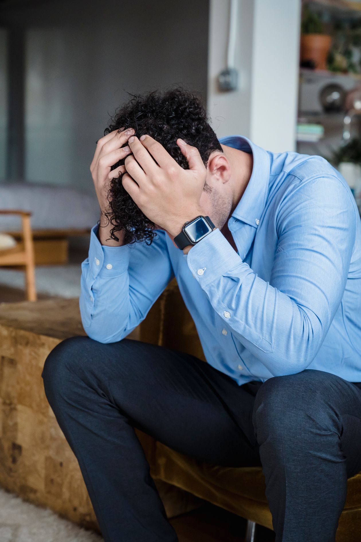 An exhausted man sitting on a couch