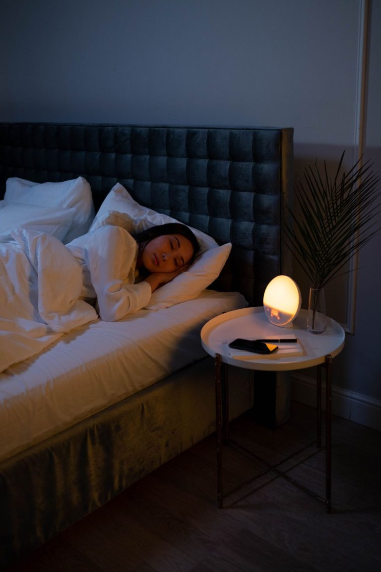Woman sleeping peacefully in a softly lit bedroom